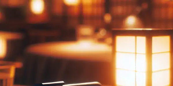 An intimate room with a smartphone, warm lighting, and subtle Japanese cultural elements, conveying spontaneity and allure.